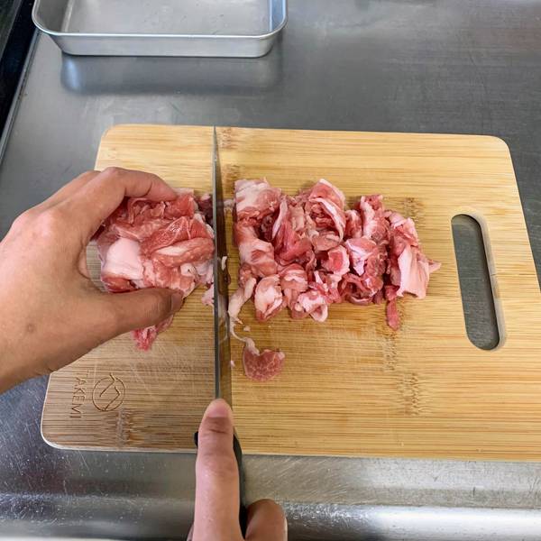 Slicing the pork into smaller pieces