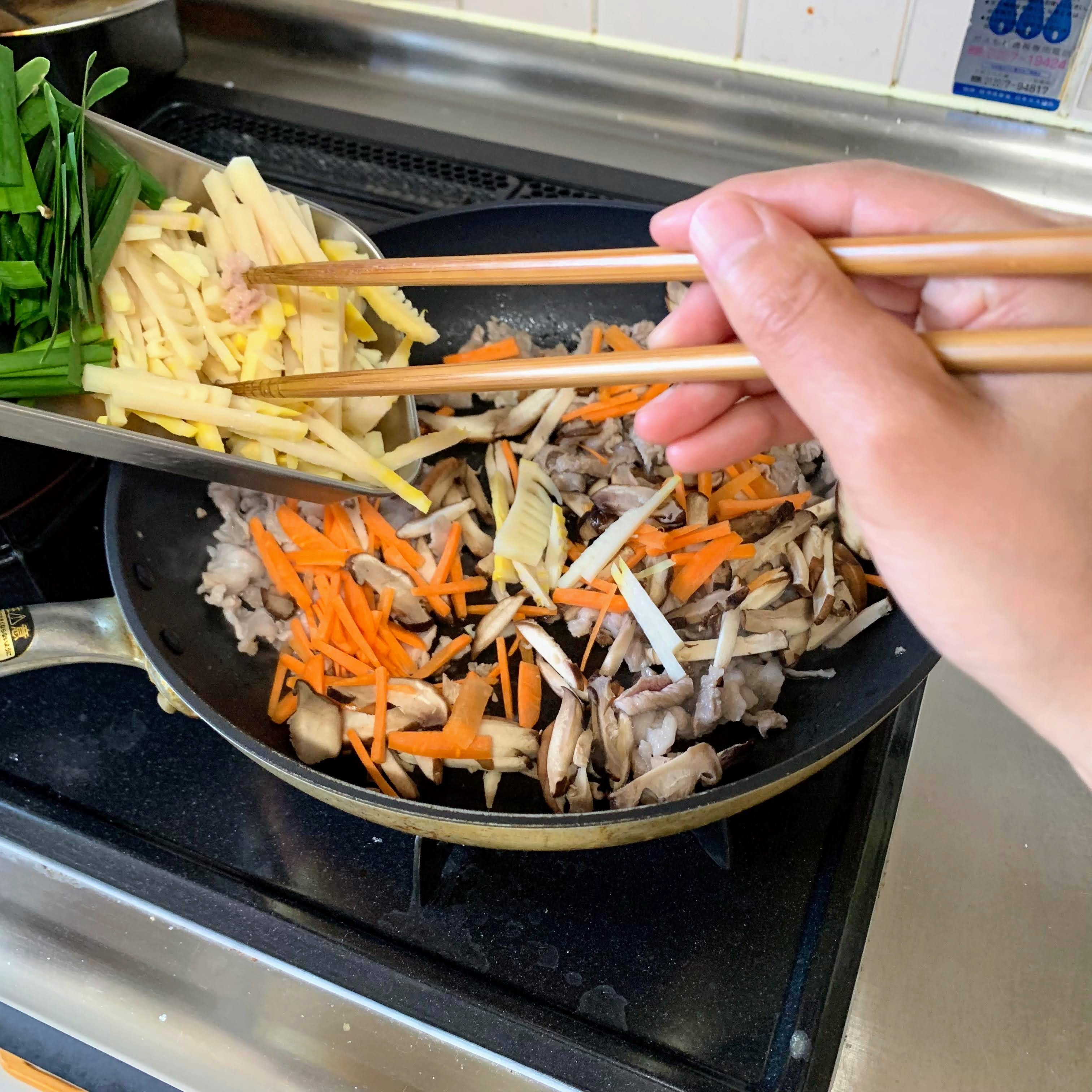 Adding the vegetables to the pork