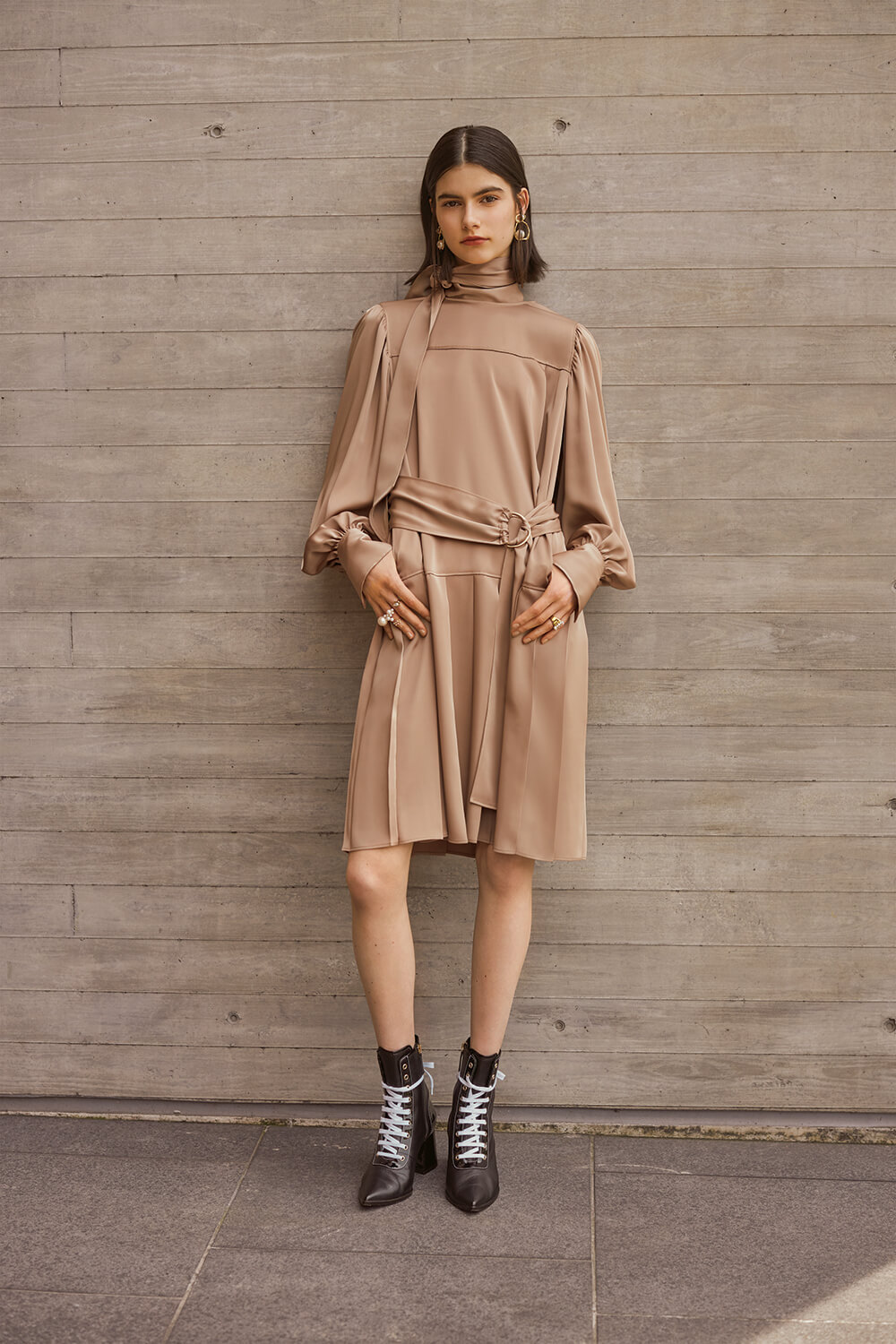 model in camel silk pleated dress