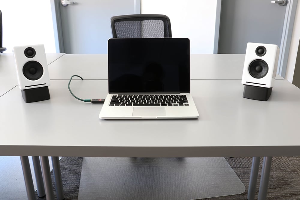 Laptop With Tilted Desktop Speaker Stands