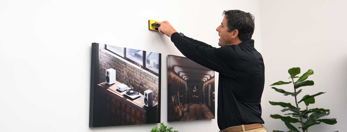 Man checking wall for obstructions with a stud finder