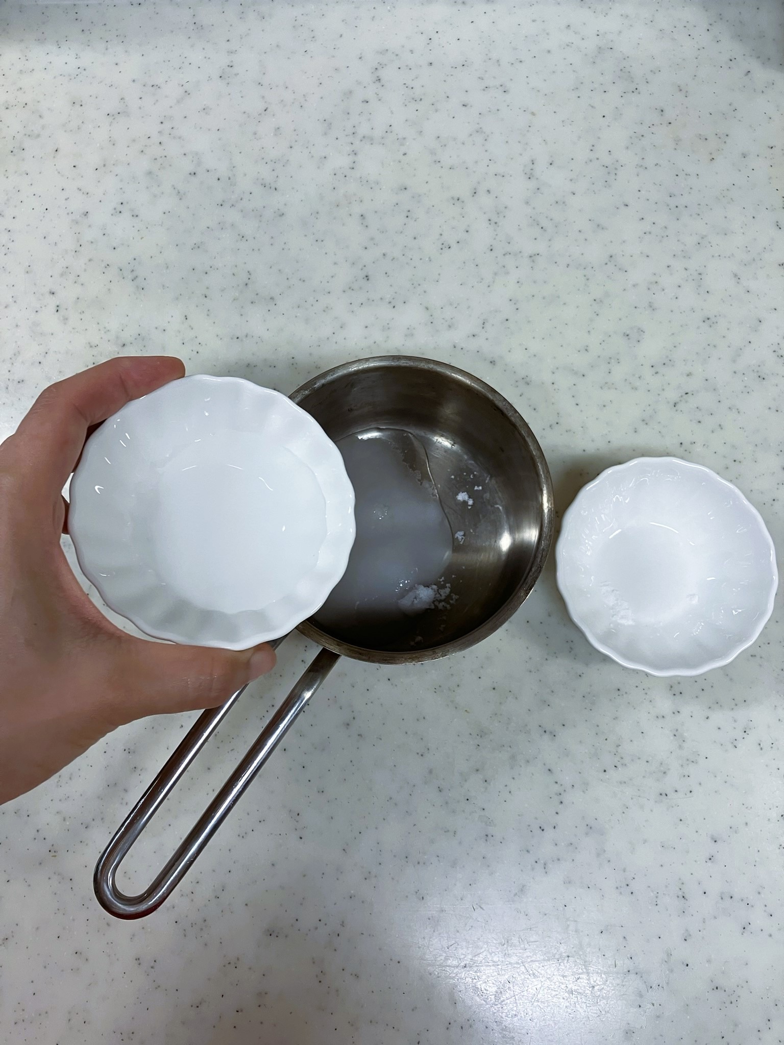 Adding the sugar and half of the water to a saucepan