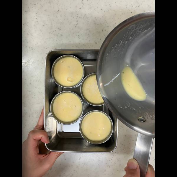 Pouring the pudding mixture evenly into the molds