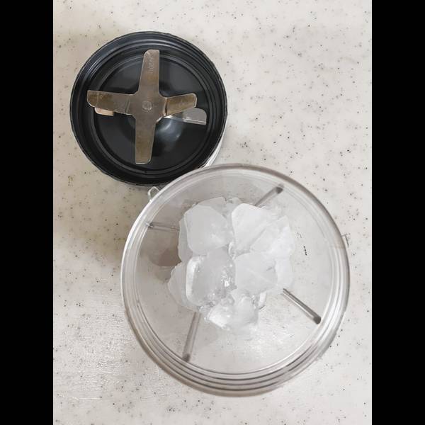 Adding ice cubes to a blender
