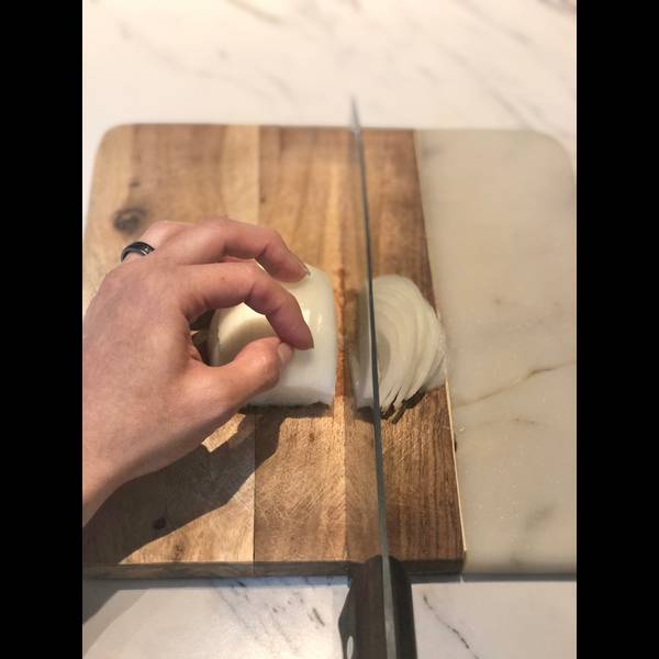 thinly slicing the onion