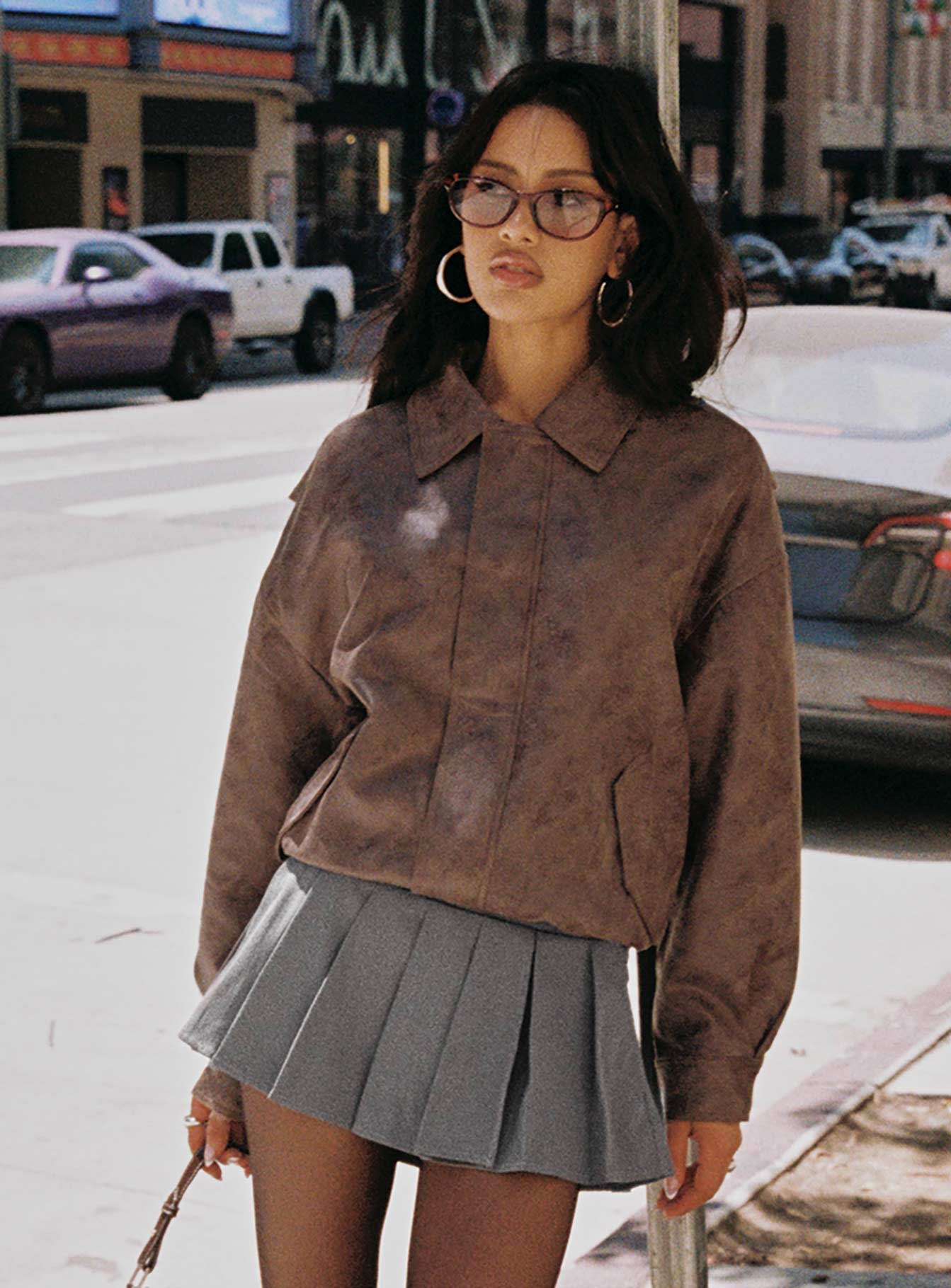 woman wearing chocolate bomber & charcoal mini skirt for fall brunch