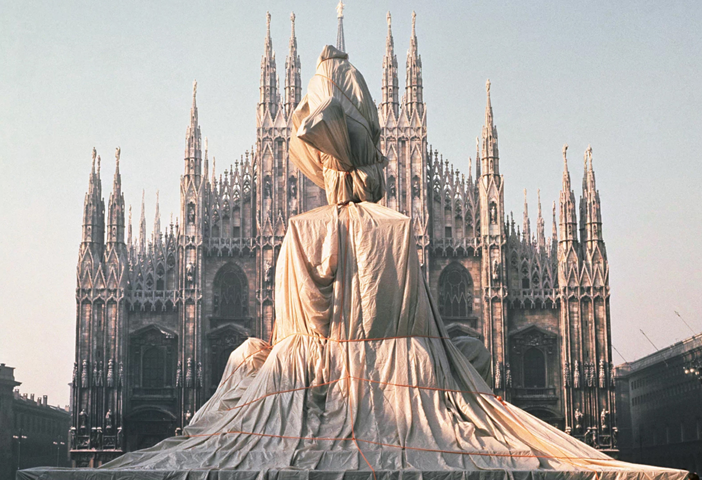 Christo and Jeanne-Claude's wrapped monument to Vittorio Emanuele II in Milan’s Piazza del Duomo in 1970. Photography by Shunk-Kender © 1970 Christo and Jeanne-Claude Foundation and J. Paul Getty Trust.