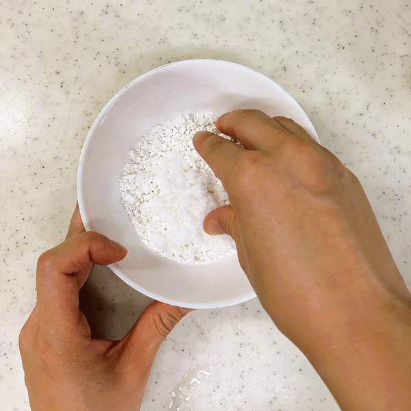 Using fingers to press the shiratama glutinous rice flour and water together into a dough
