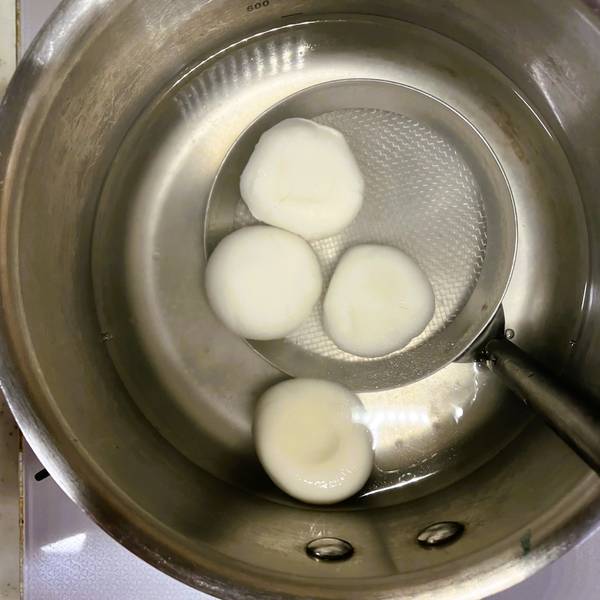 Taking the shiratama dango out of the boiling water once they are fully cooked