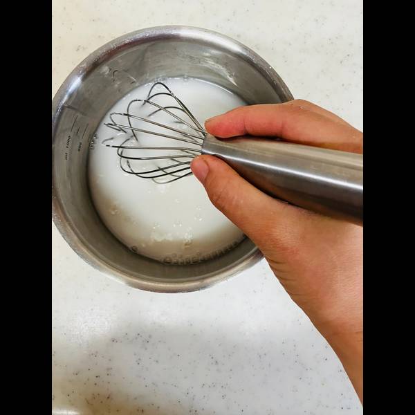 Using a whisk to mix the ingredients together