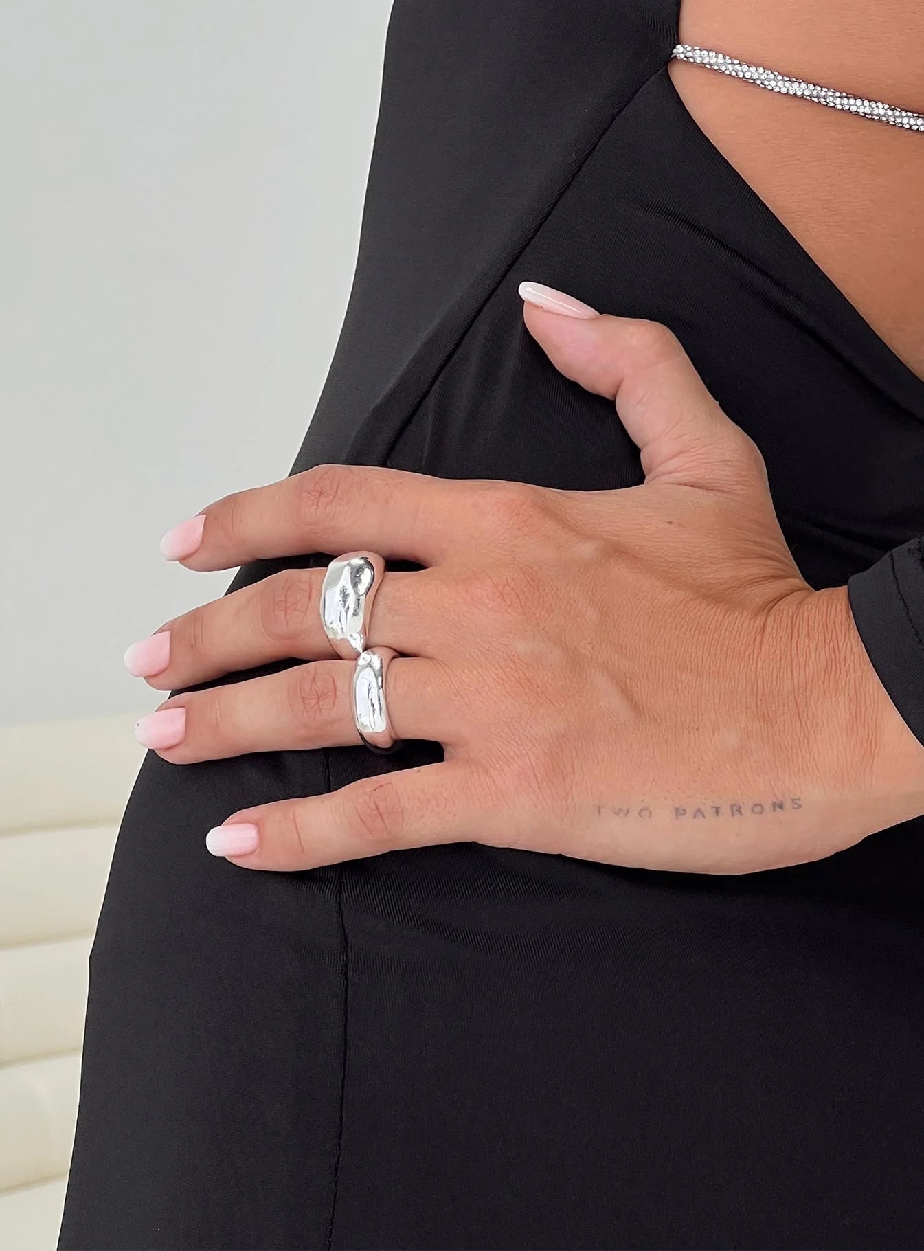 woman wearing silver rings for cocktail party