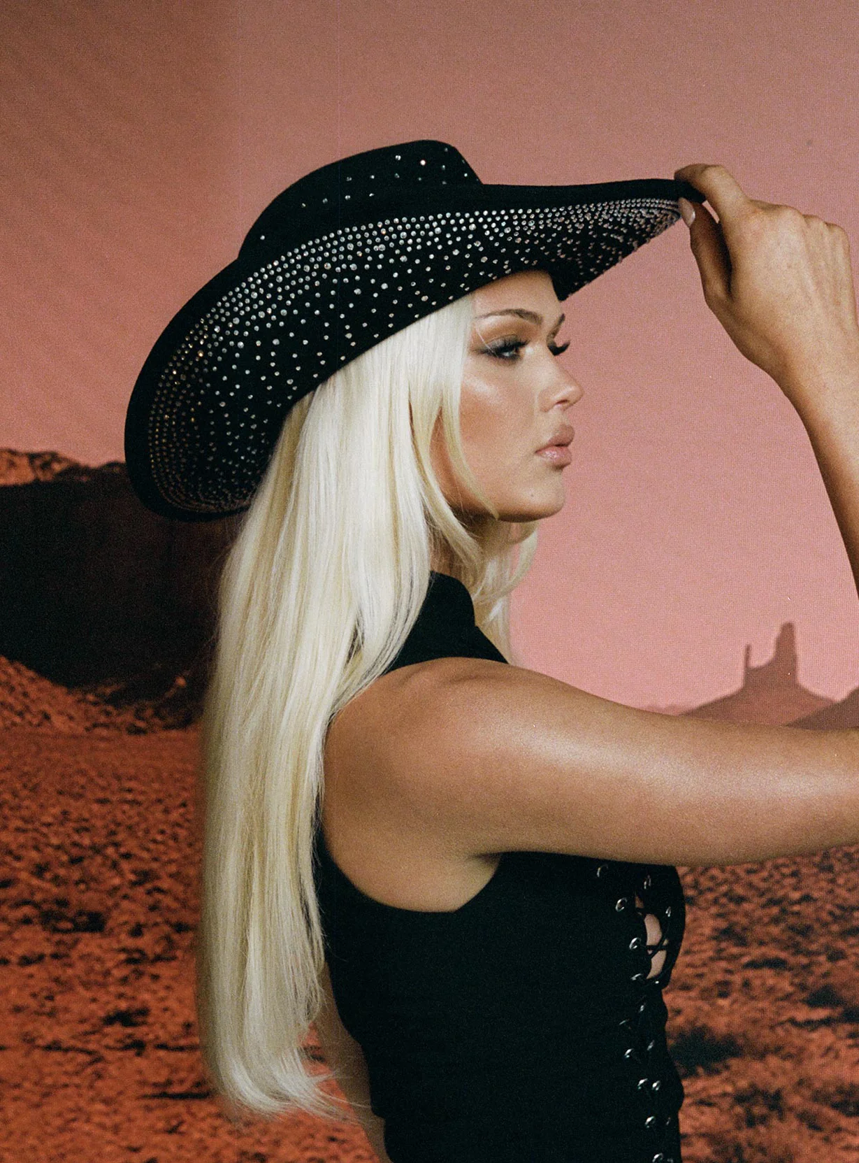 woman wearing cowgirl hat