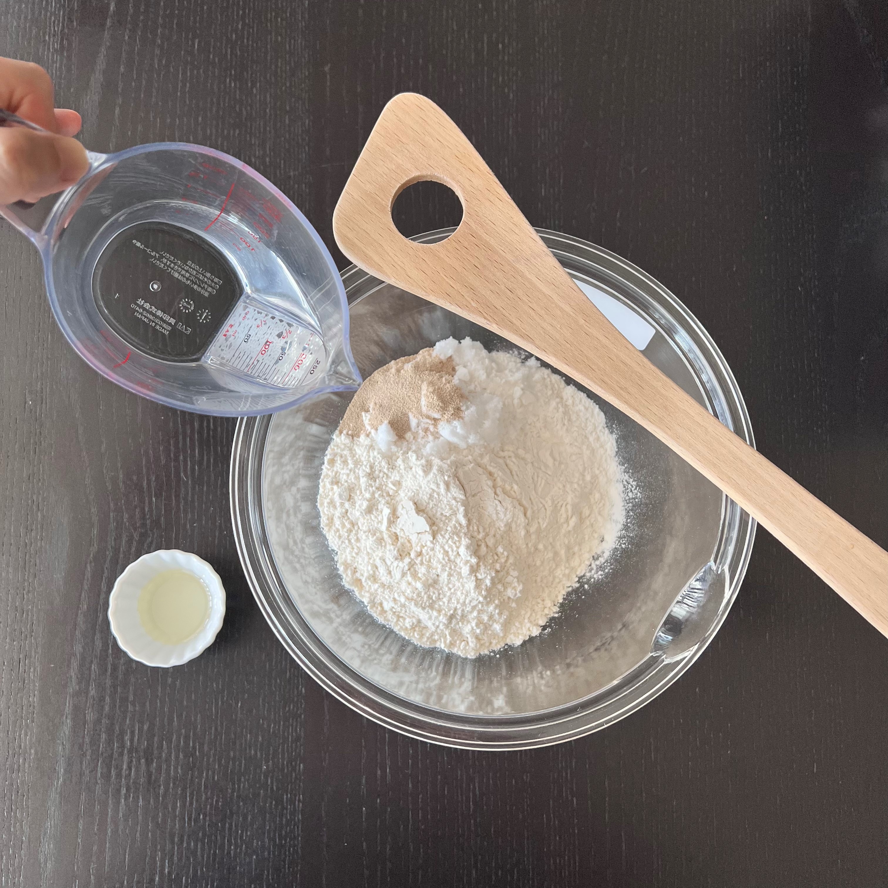 Adding the water into the dry ingredients