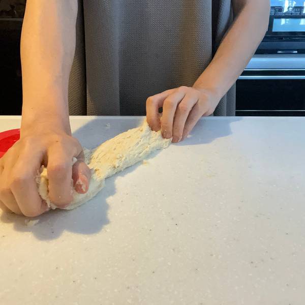 Stretching the bread dough to work the gluten