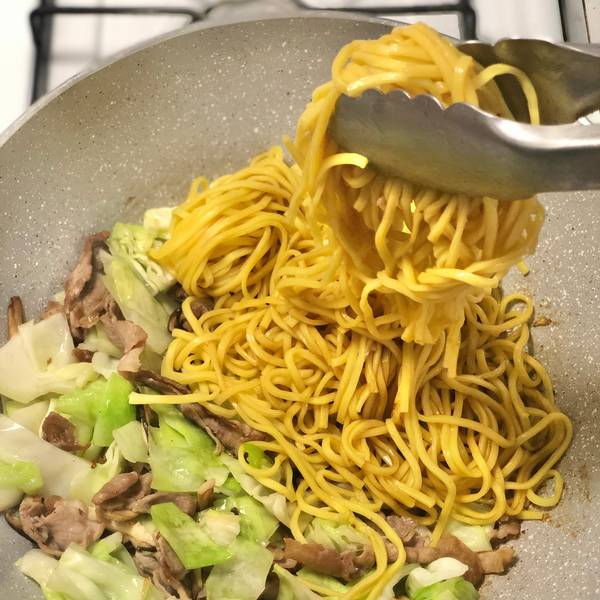 Tossing the noodles in the yakisoba sauce