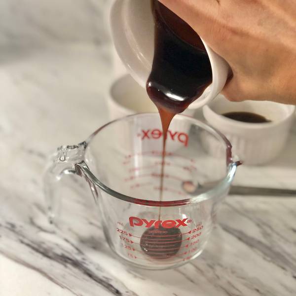 Adding the oyster sauce into a measuring cup