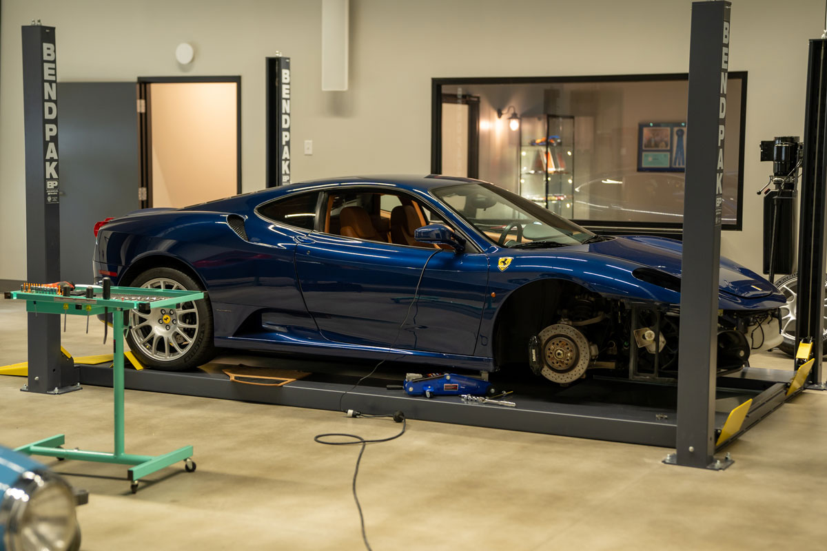 Car garage showcase with a blue car being worked on