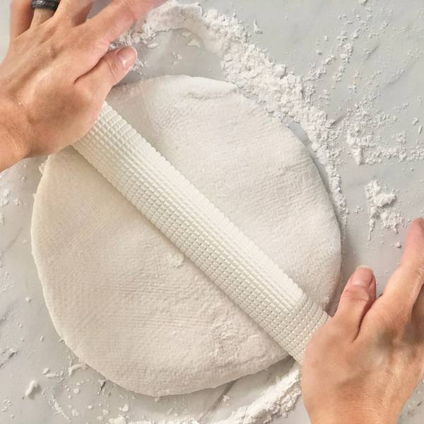Rolling the dough out using a rolling pin