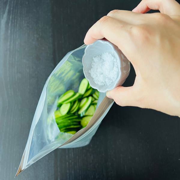 adding the cucumbers and salt to the ziplock bag