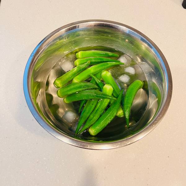 cooling the blanched okra in an ice bath