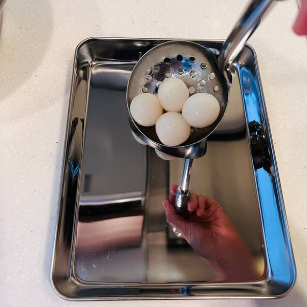 Transfering cool and drained dango to a separate tray