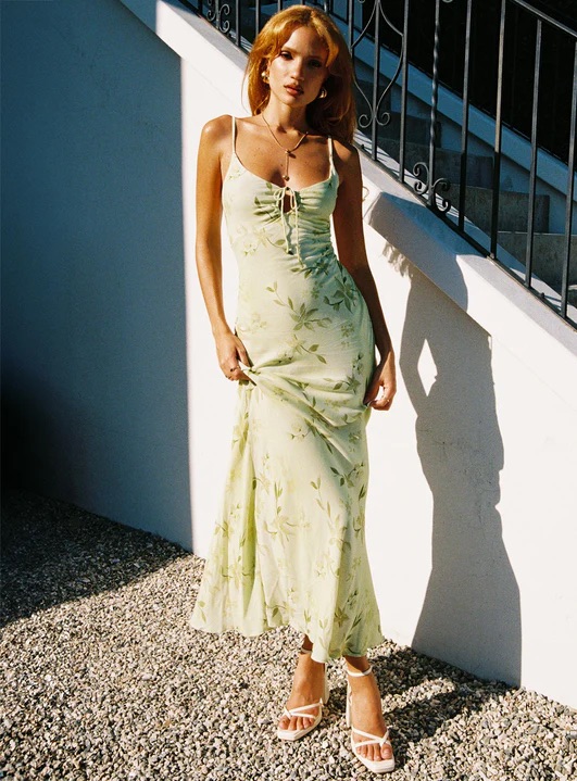 woman wearing floral green maxi dress for black tie optional wedding