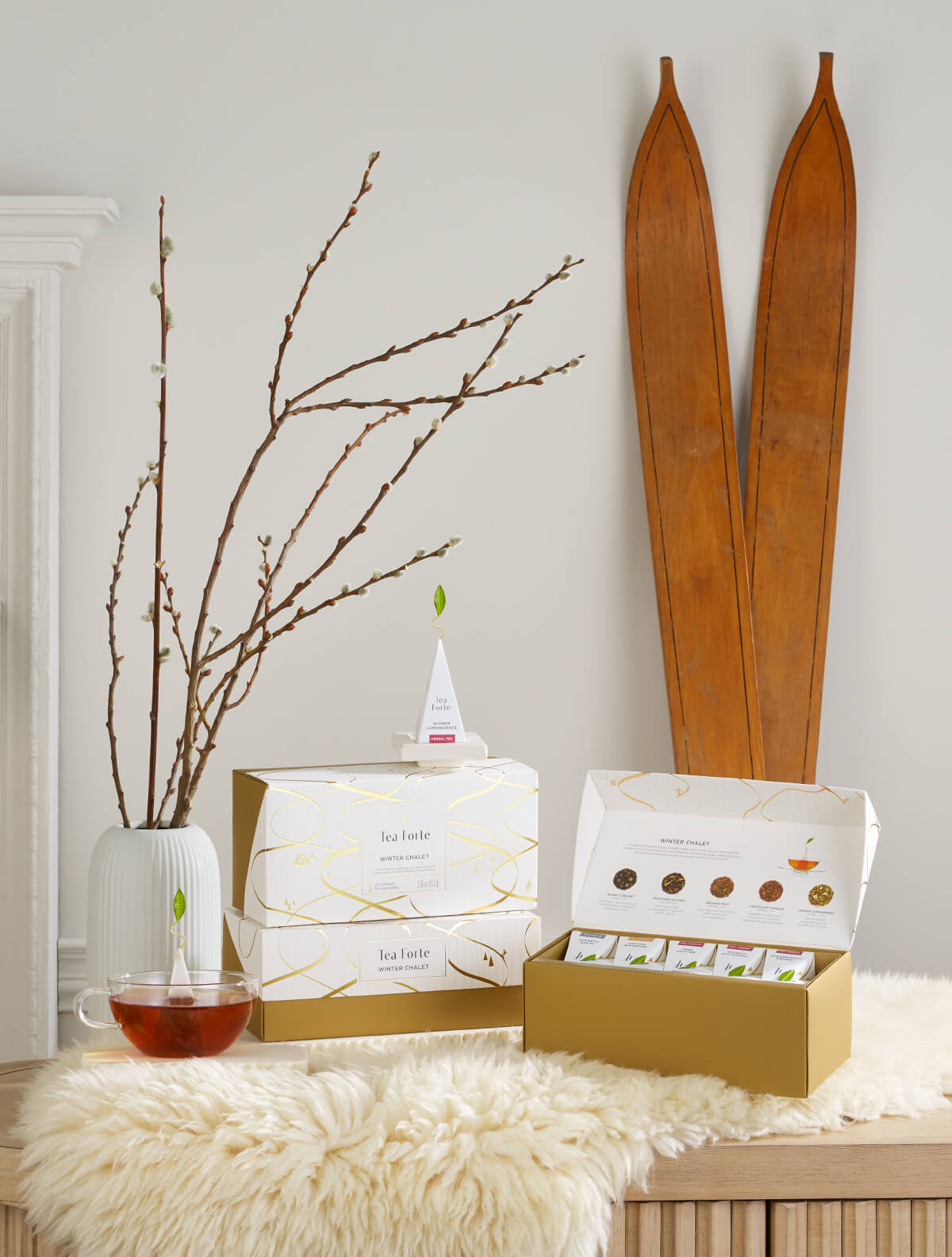 The Winter Chalet Collection ona fuzzy throw with wooden antique skiis