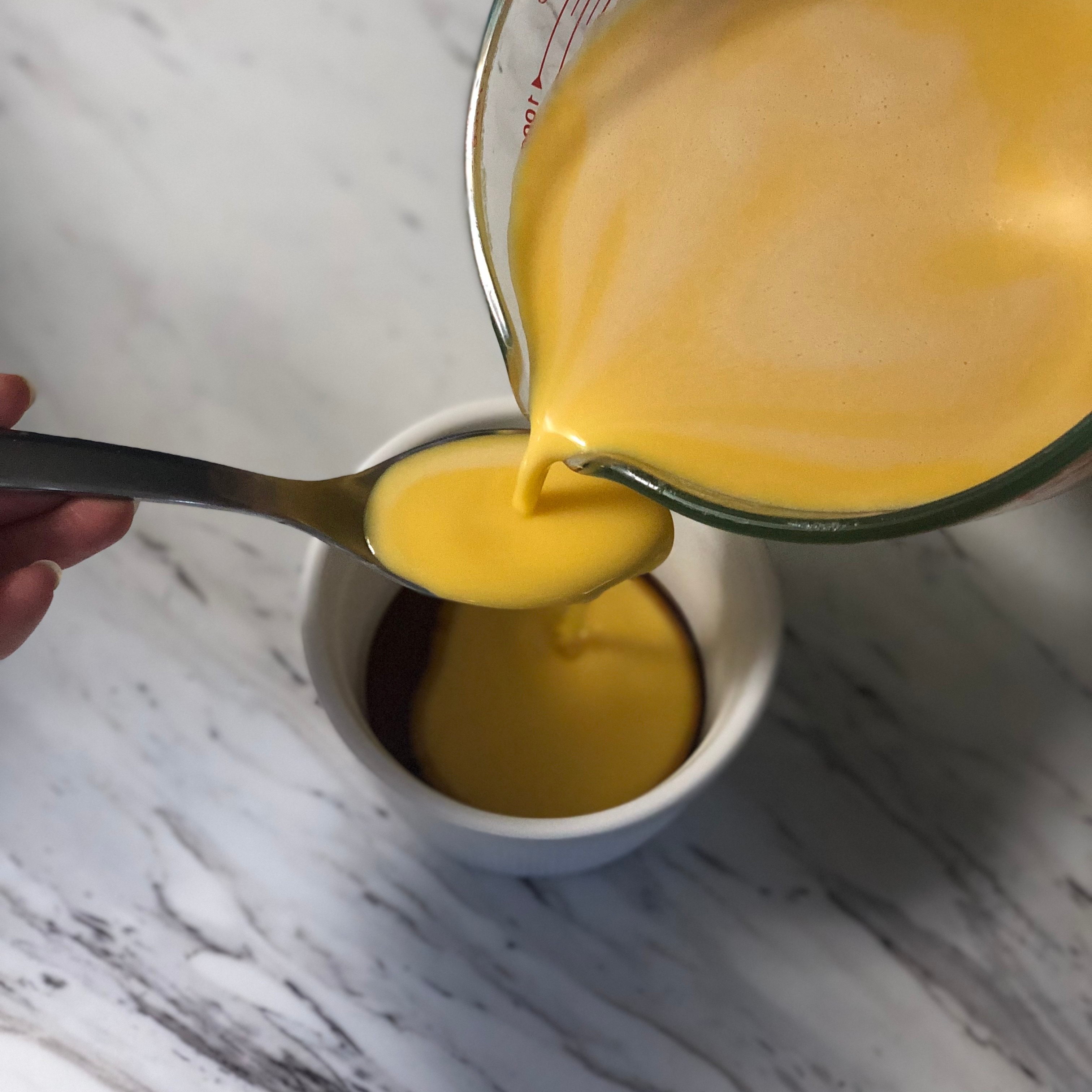 Pouring the kabocha pudding mixture into ramekins
