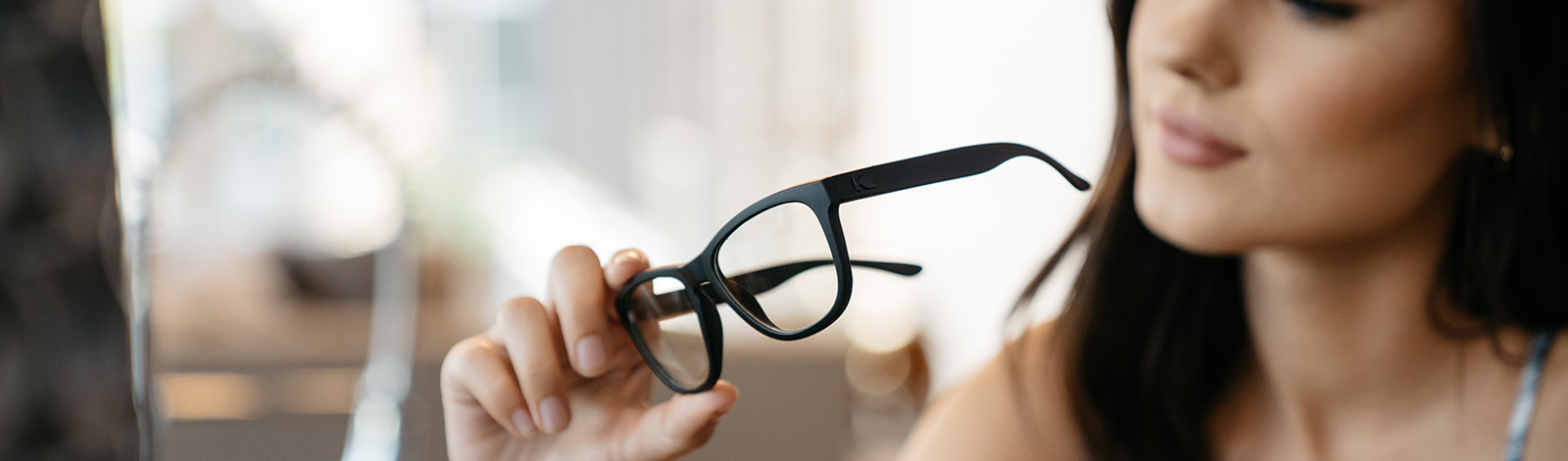 Model Wearing Holding Blue Light Blockers 