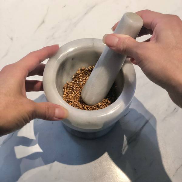 grinding the sesame seeds