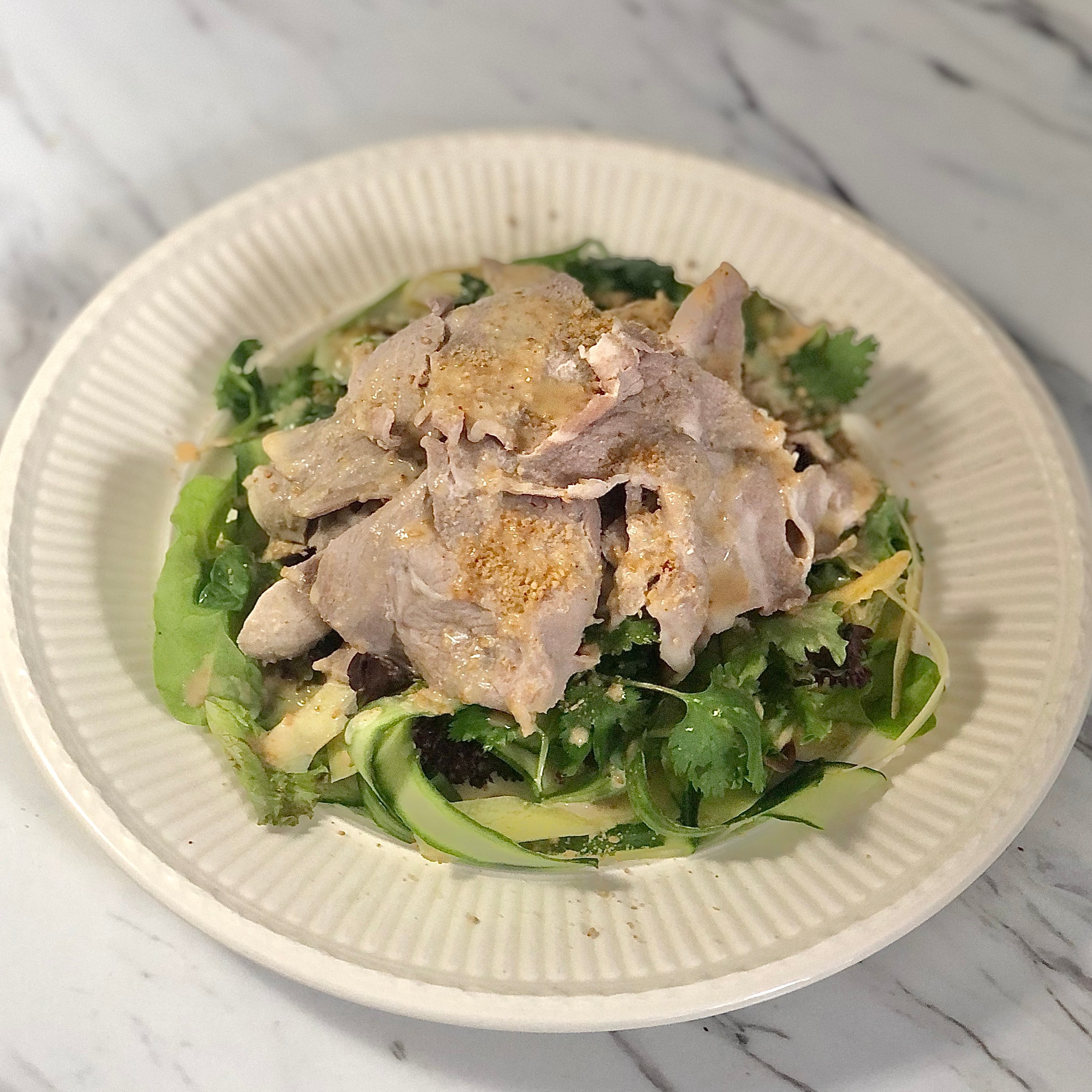 finished and plated shabu shabu salad with sesame dressing