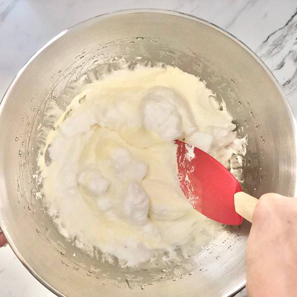 Adding the egg whites into the yolks