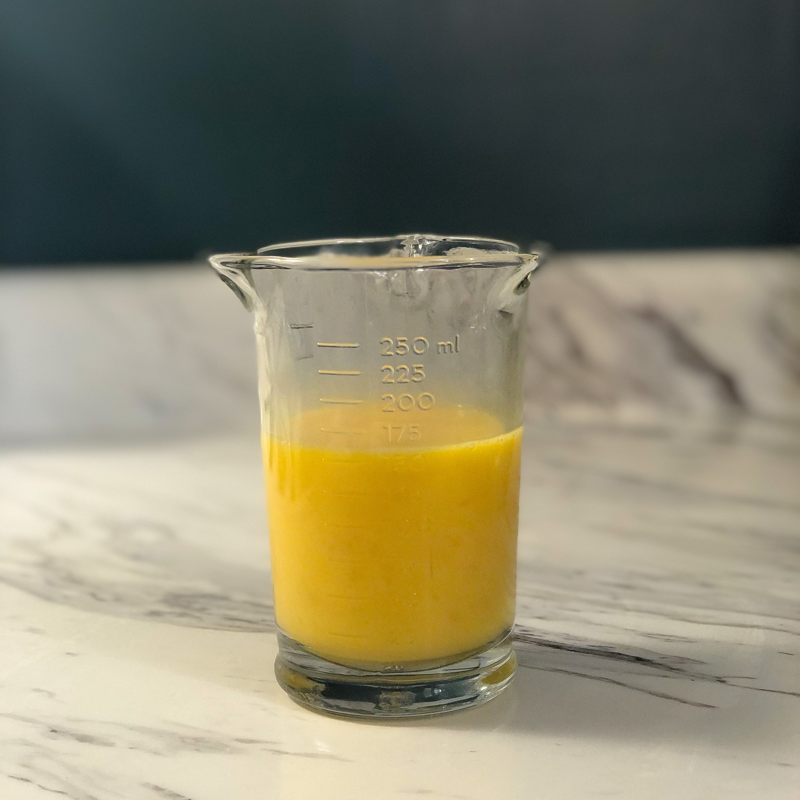 Adding the beaten eggs to a measuring cup