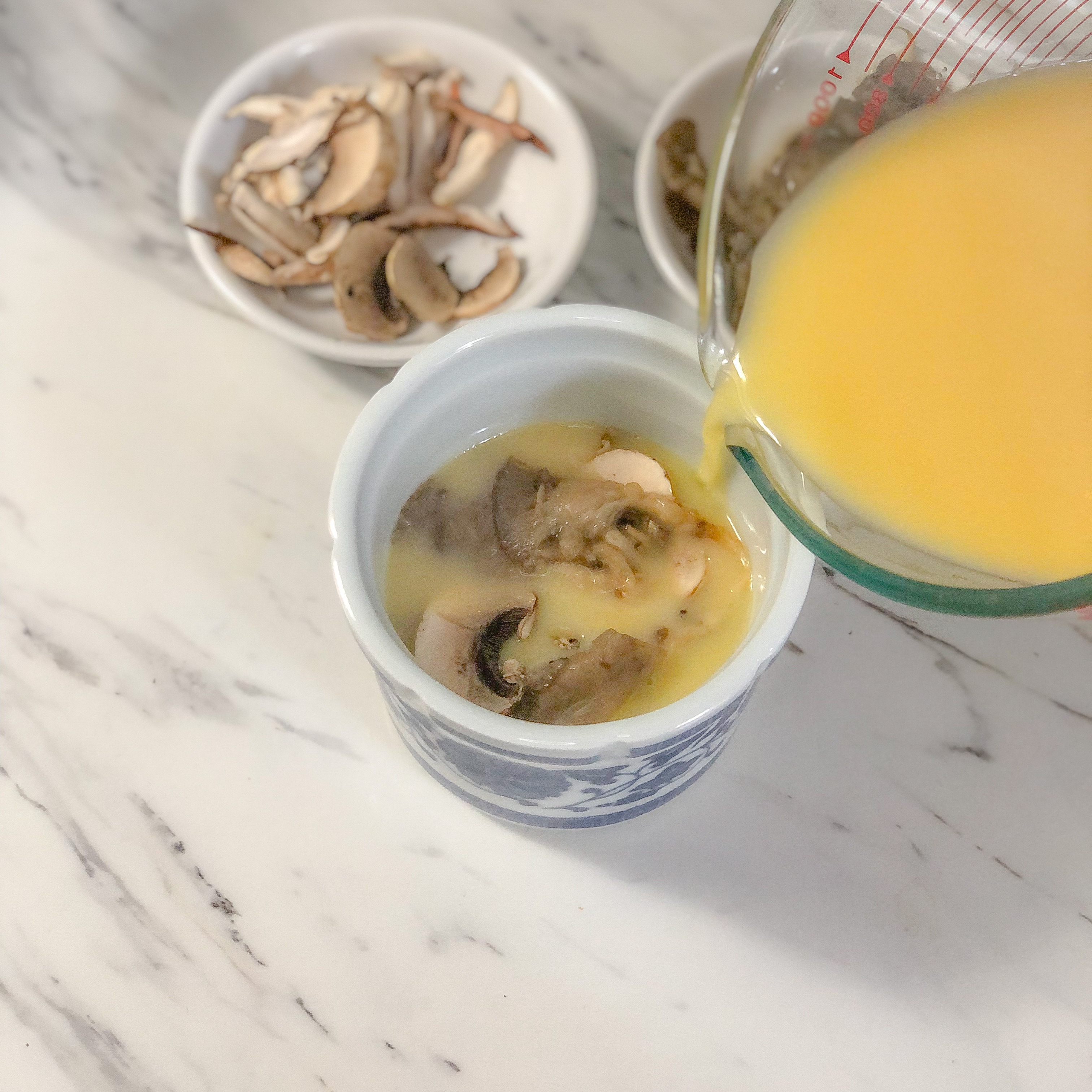 Filling the container with the egg mixture until the top