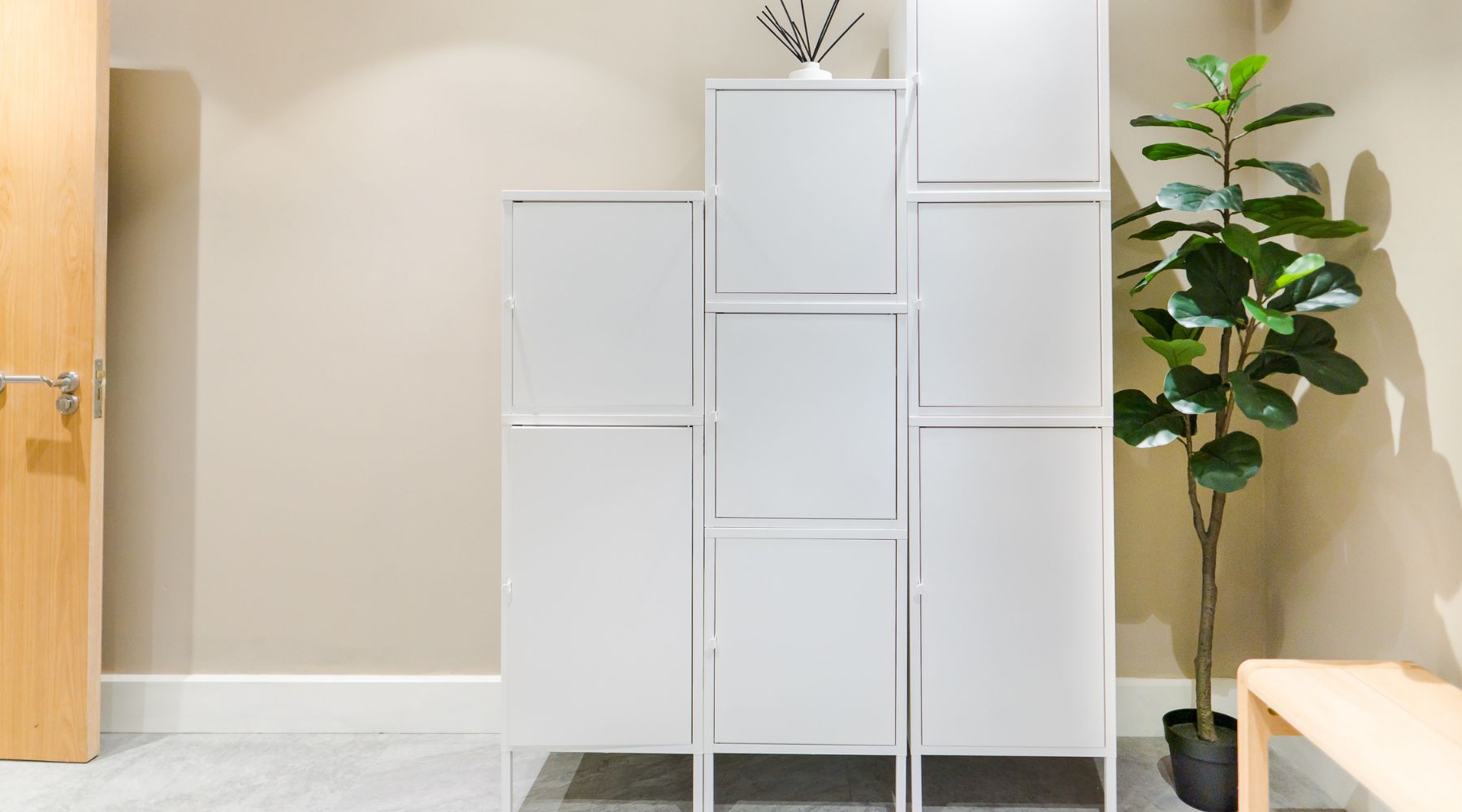 Lockers in the VIM Health changing room including biophilia and wooden bench.