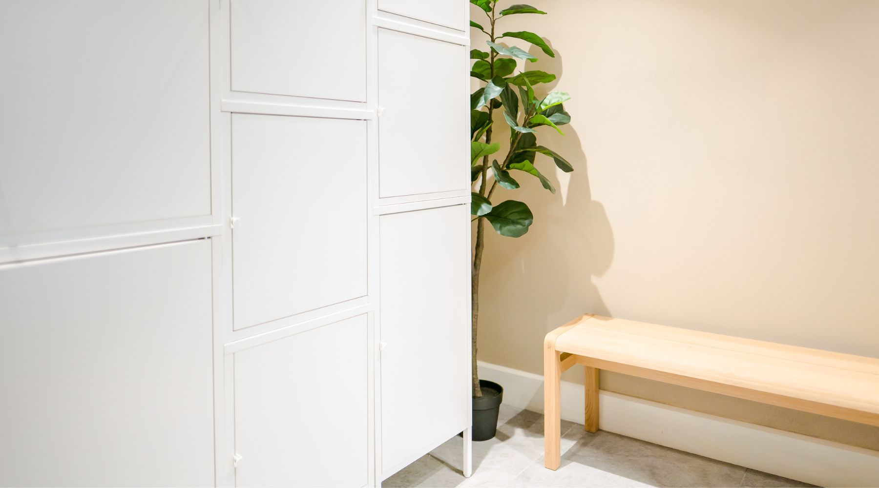 Lockers in the VIM Health changing room including biophilia and wooden bench.