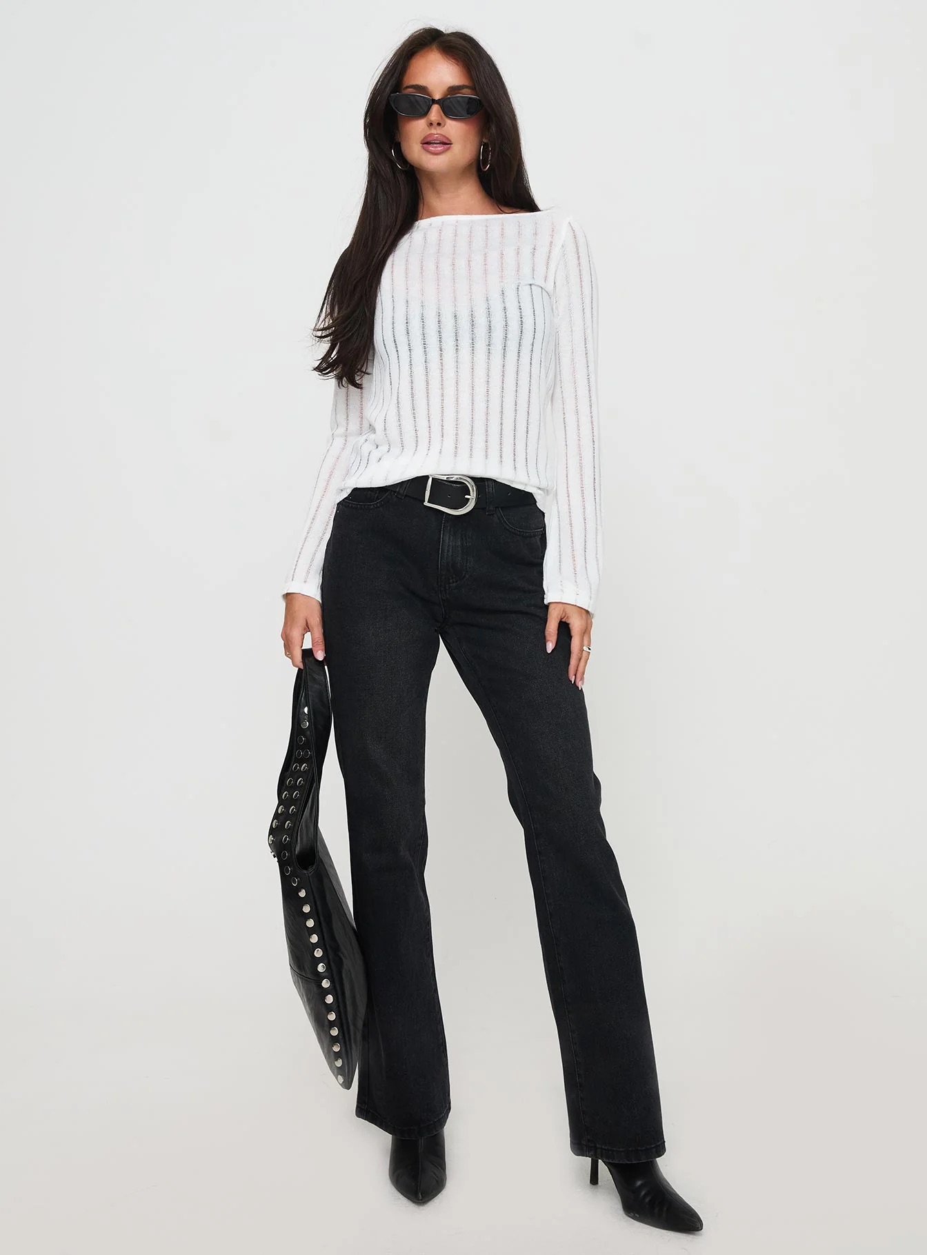 woman wearing black bootleg jeans