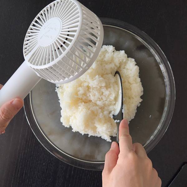 cooling the rice with a fan