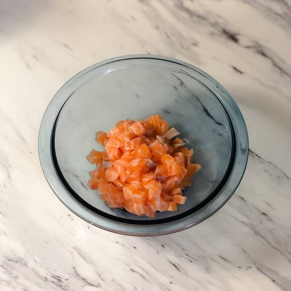 placing the sashimi grade salmon in a bowl