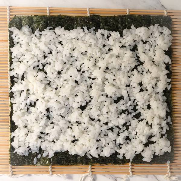 placing the sushi rice on the nori