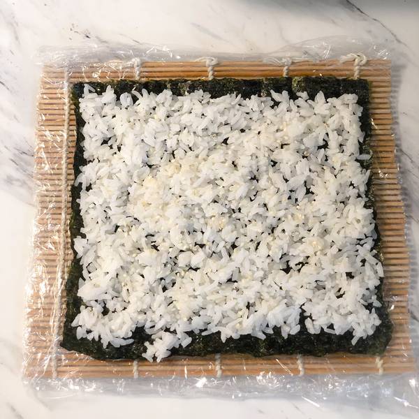 placing rice onto the nori