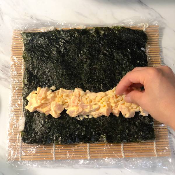 flipping the nori over and then adding the fillings