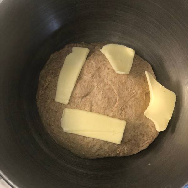 adding butter to the dough