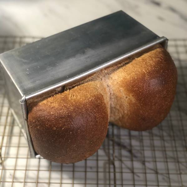 tapping the bread pan onto a wire rack