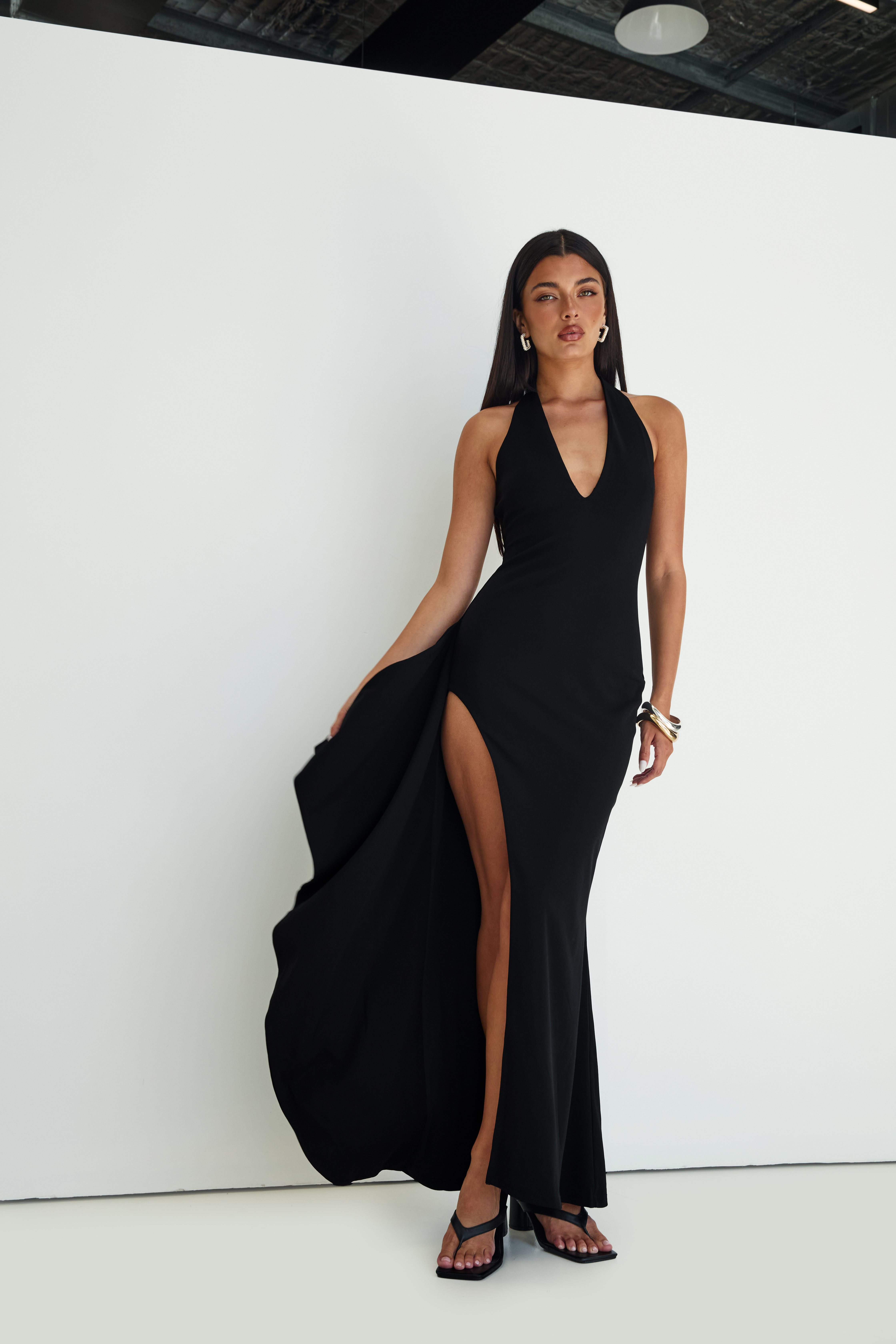 woman wearing black maxi dress to formal christmas party
