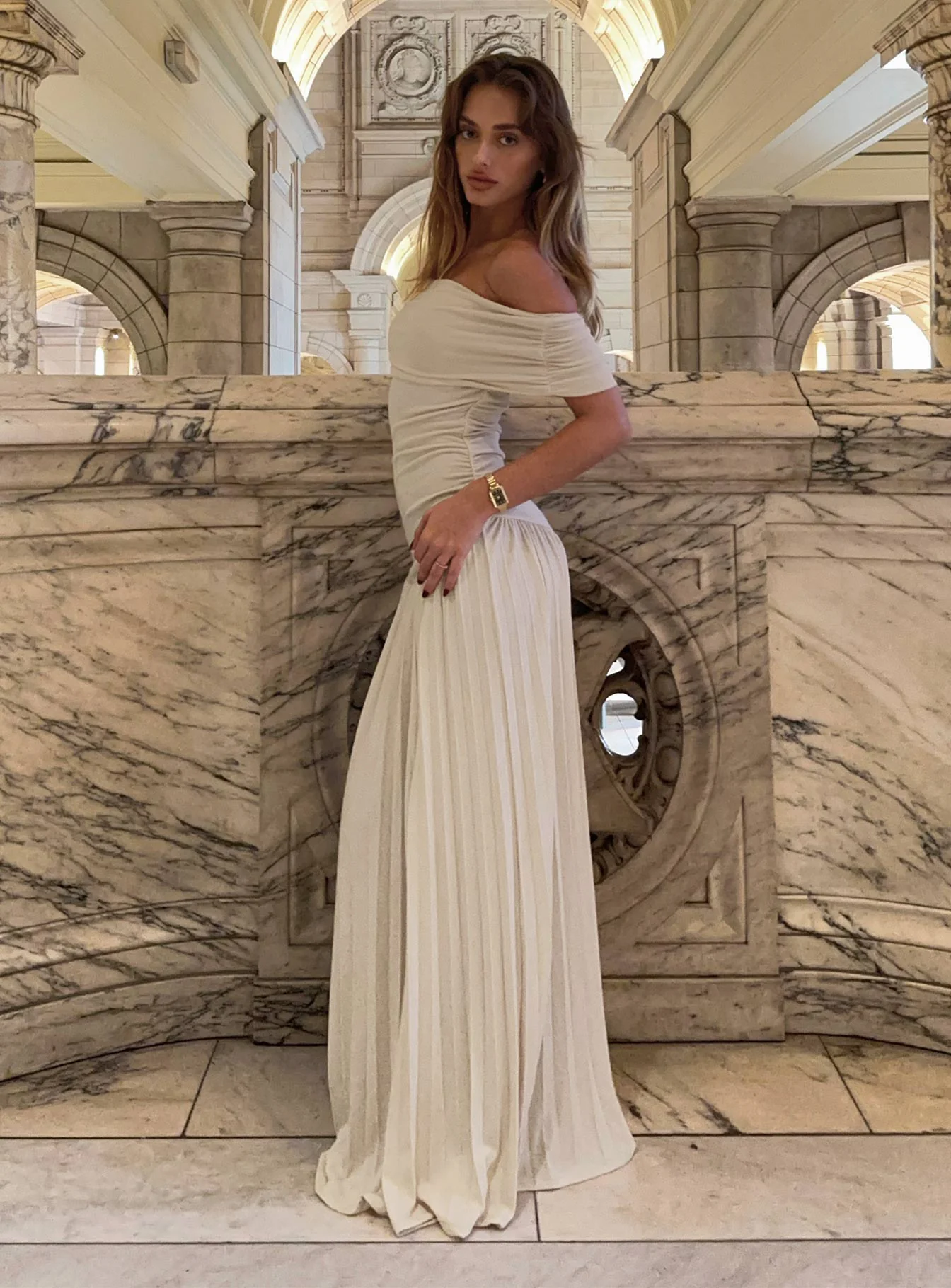 woman wearing beige maxi dress for semi formal winter wedding