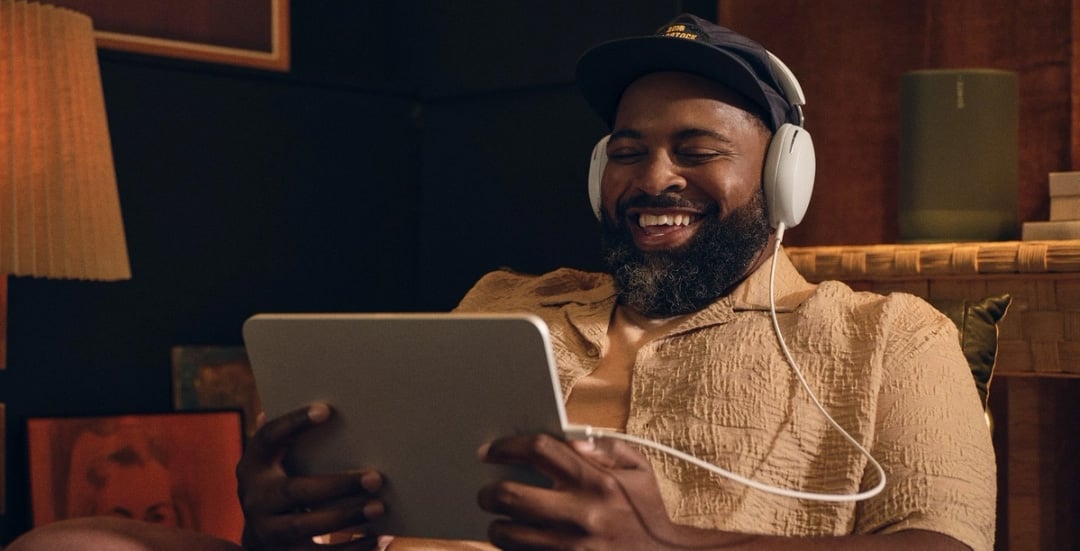 Smiling man with headphones on.