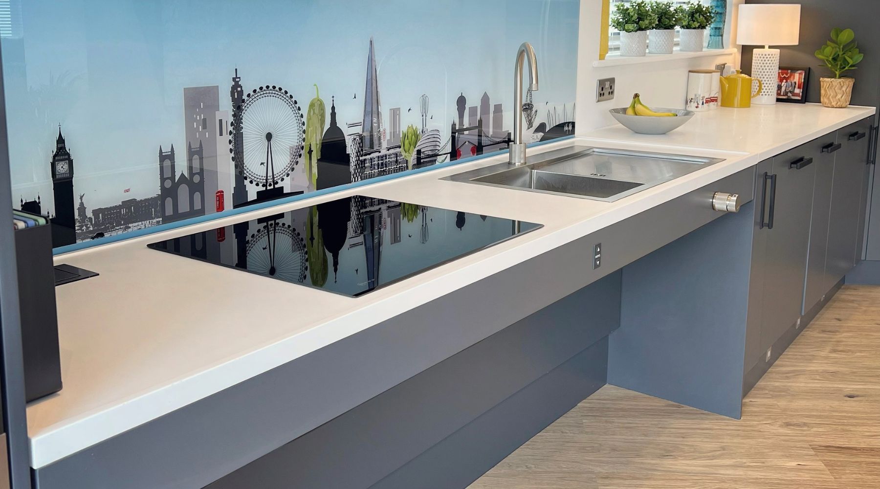 Accessible kitchen with wheelchair clearance under the units and a worktop splashback of the London skyline 