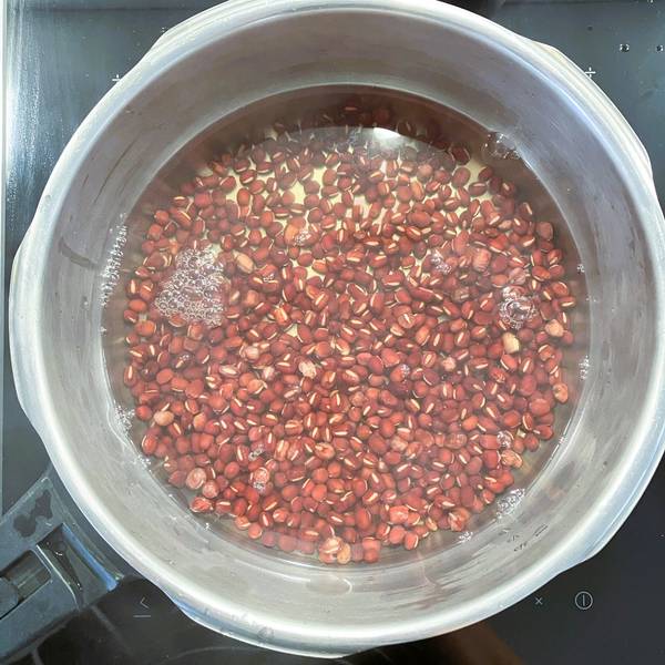 submerging the beans in water and bringing to a boil