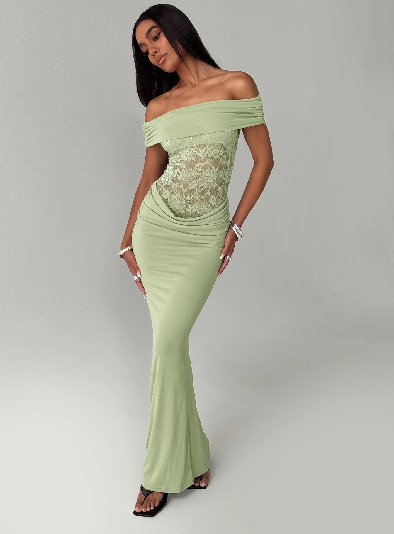 woman wearing off the shoulder green maxi dress to black tie spring wedding